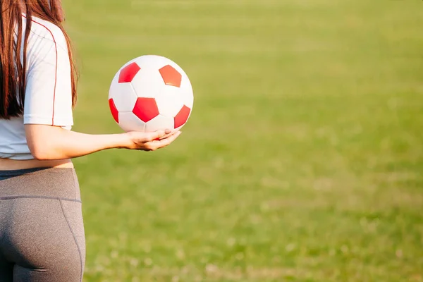 Soccer ball in hand view from back. copy space. close-up. footba — Stock Photo, Image