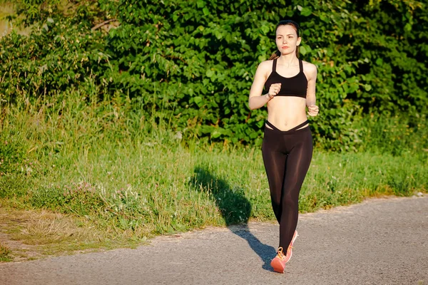 young woman running in park