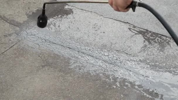 Working with a gas burner melts the tar up on the roof for future roof repairs — Stock Video