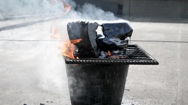 Melting bitumen on the grid in the bucket by fire for a roof repair — Stock Video