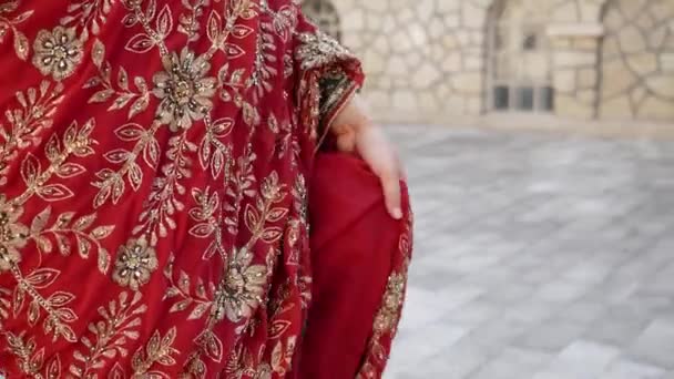Close up beautiful ethnic Indian Saree. Young woman in red, colorful, sensual, wedding and very feminine outfit - Indian sari walks along old streets in India — Stock Video