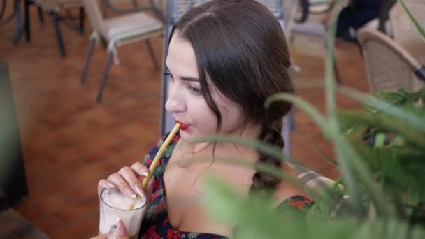 Belle jeune femme brune en été café cocktail à boire à travers la paille — Video