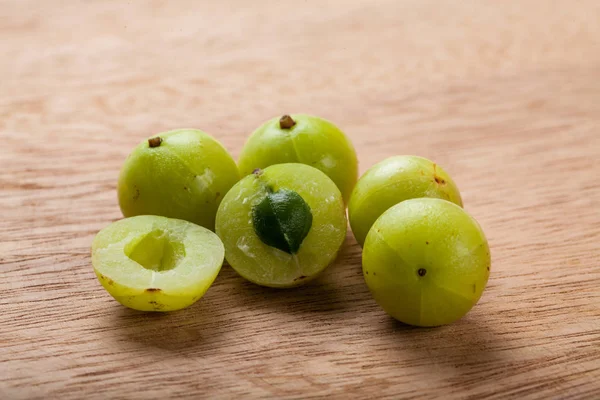 Fresh Indian gooseberry on wood Chopping Board background.