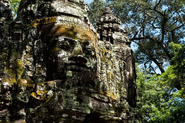 Faces of Buddha beyond the arch of ancient city, Angkor Thom, Cambodia.