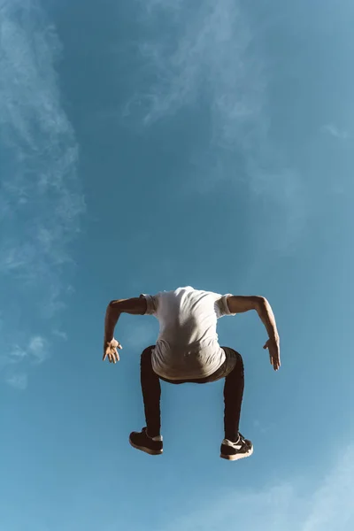 young sportsman practicing parkour.