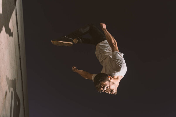 young sportsman practicing parkour.