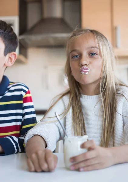 Niños felices comiendo un yogur . —  Fotos de Stock