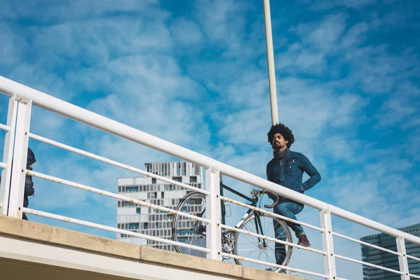 Hombre con pelo afro montando una bicicleta de estilo vintage — Foto de Stock