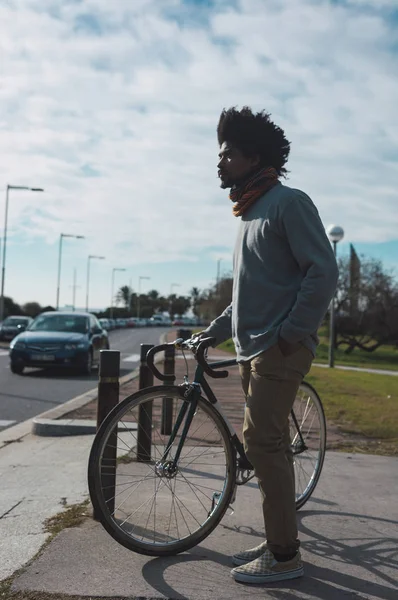 Hombre con pelo afro montando una bicicleta de estilo vintage — Foto de Stock