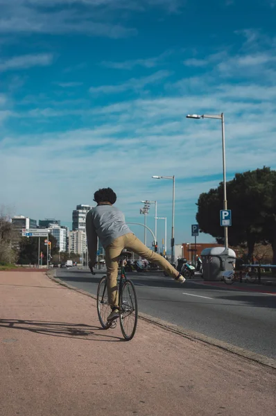 Homem com cabelo afro montando uma bicicleta estilo vintage — Fotografia de Stock