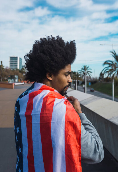 Man with afro hair proudly showing the American flag 