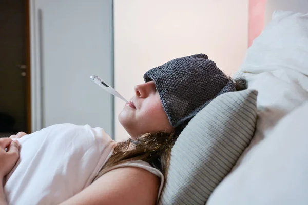 Sick teenage girl with a high fever. — Stock Photo, Image