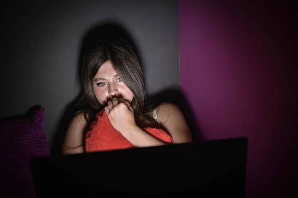 Teenage girl is afraid to watch a horror movie — Stock Photo, Image