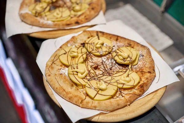 Cook in the kitchen putting the ingredients on the pizza. Pizza concept. Production and delivery of food. selective focus.