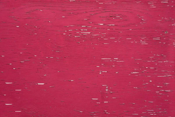 Horizontal red barn board wall from Old Barn. Textured and peeling red paint from old farm building. Close up