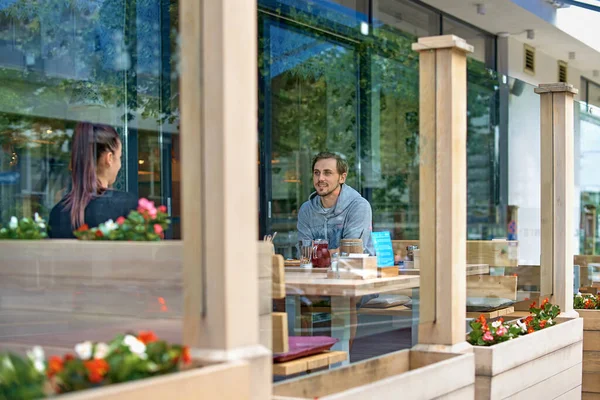 Young couple sit on the terrace according to the new rules of social distance. Conceptual new normal lifestyle for people to reduce the virus — Stock Photo, Image