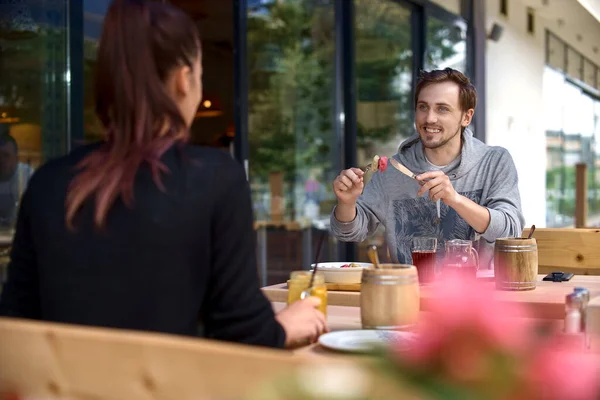 Young couple sit on the terrace according to the new rules of social distance. Conceptual new normal lifestyle for people to reduce the virus — Stock Photo, Image