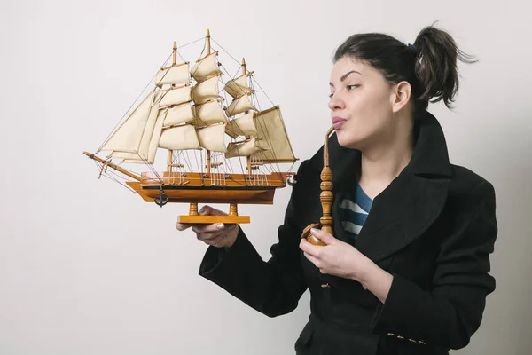 woman with wooden ship model