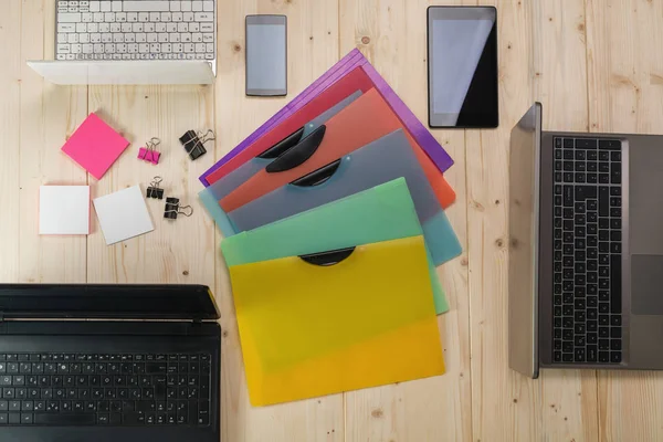 colorful plastic folders on working place