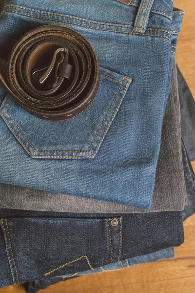 stack of jeans and belt on top