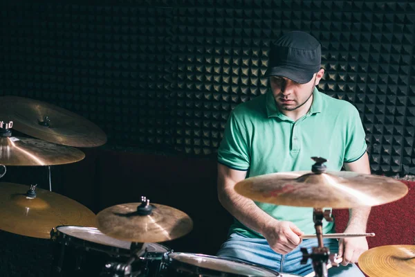 Drummer playing drums at recording studio