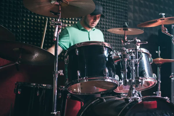 Drummer playing drums at recording studio