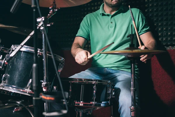 Drummer playing drums at recording studio
