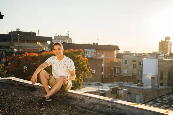handsome young man posing on rooftop