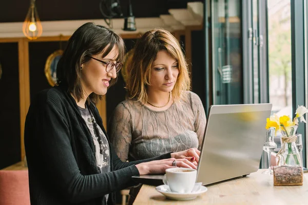 young women working with laptop in coffee shop