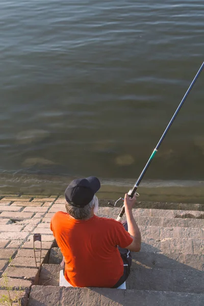 Senior adult man fishing on a river