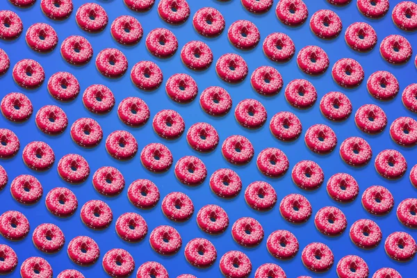 rows of pink glazed doughnuts on blue background
