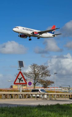 Londra - Kasım 2018: Londra Heathrow Havaalanı uyarı sürücülerin düşük uçan aircarft, A30 Road'da yol işareti. Arka planda bir n uçak lcoming gelecek.