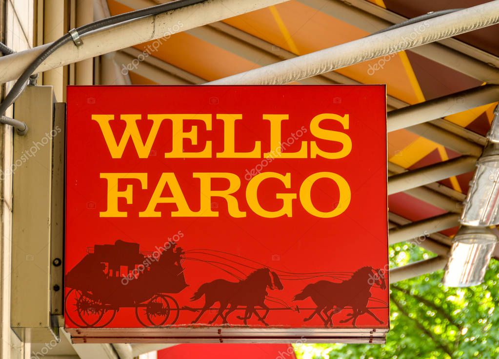 SEATTLE, WA, USA - JUNE 2018: Close up view of the sign outside the entrance to a branch of the Wells Fargo bank in Seattle city centre.