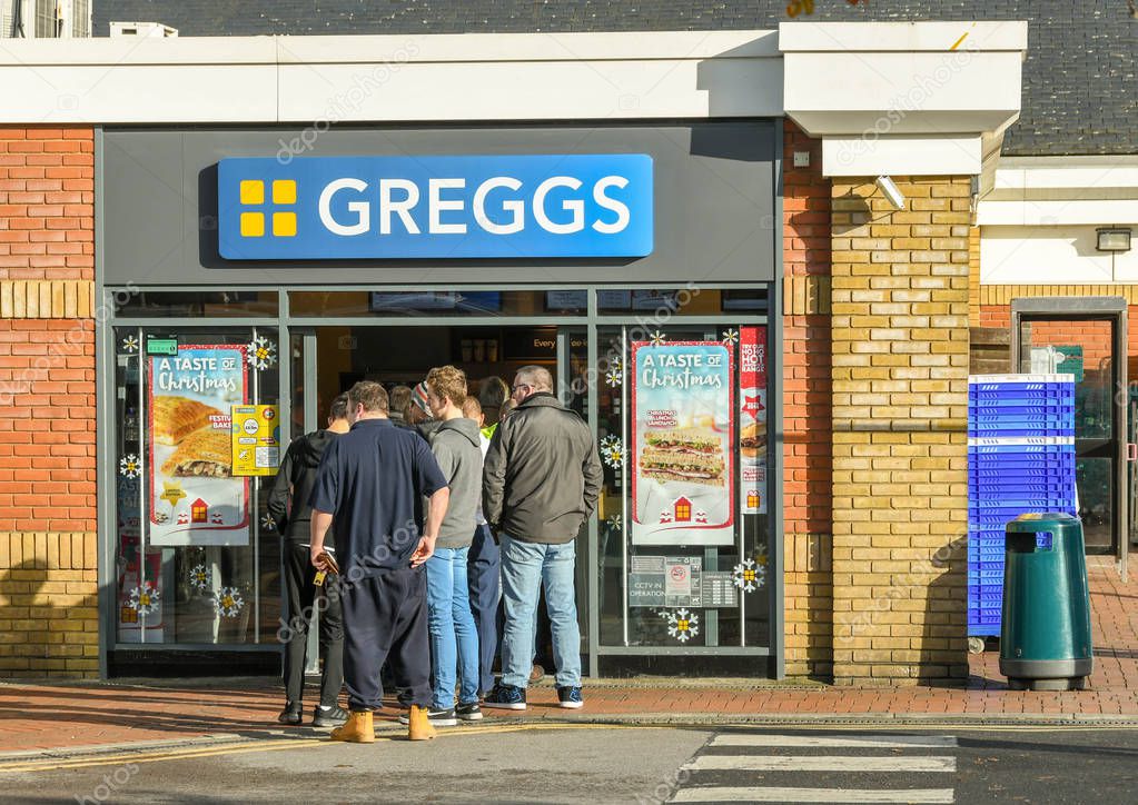 M4 SERVICES, READING, ENGLAND - NOVEMBER 2018: Customers queuing outside the door at the popular branch of Greggs bakery at the service station on the M4 in Reading.