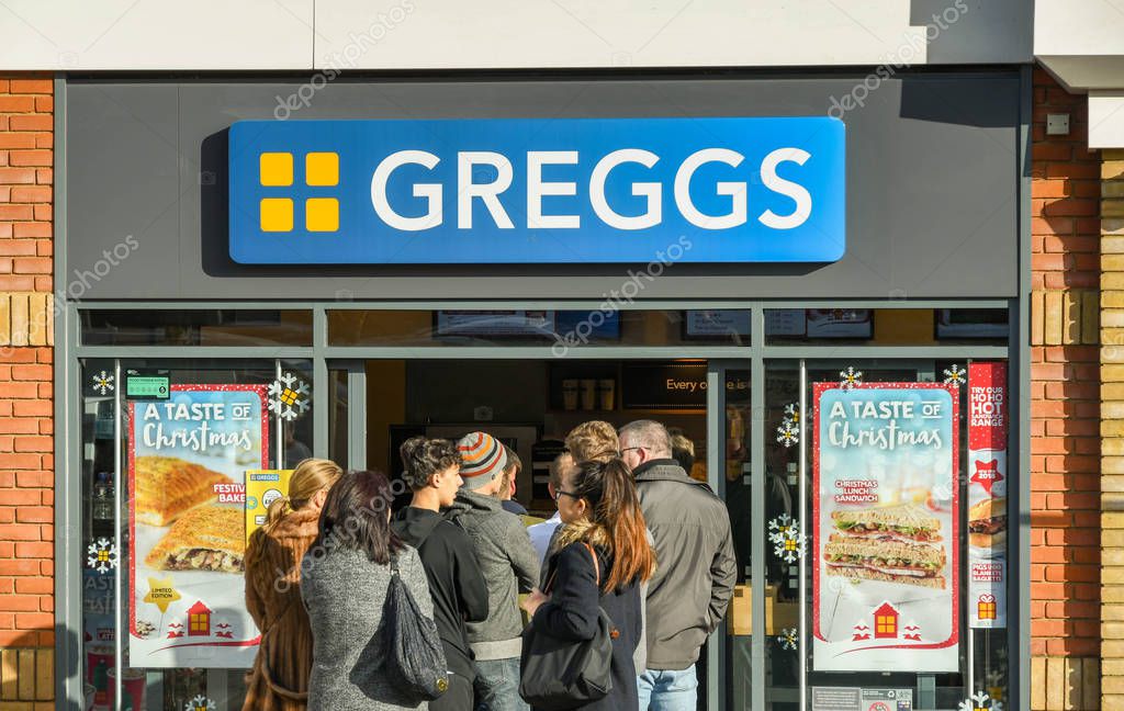 M4 SERVICES, READING, ENGLAND - NOVEMBER 2018: Customers queuing outside the door at the popular branch of Greggs bakery at the service station on the M4 in Reading.