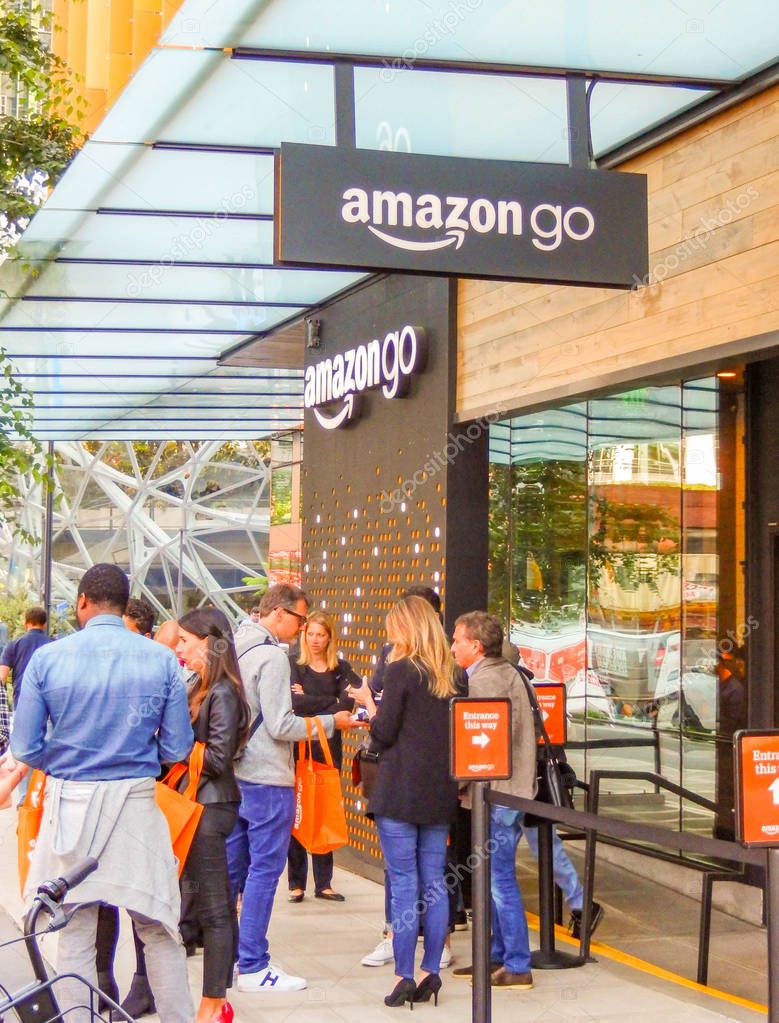 SEATTLE, WA, USA - JUNE 2018: Signs ans shoppers outside the Amazon Go store in Seattle city centre.