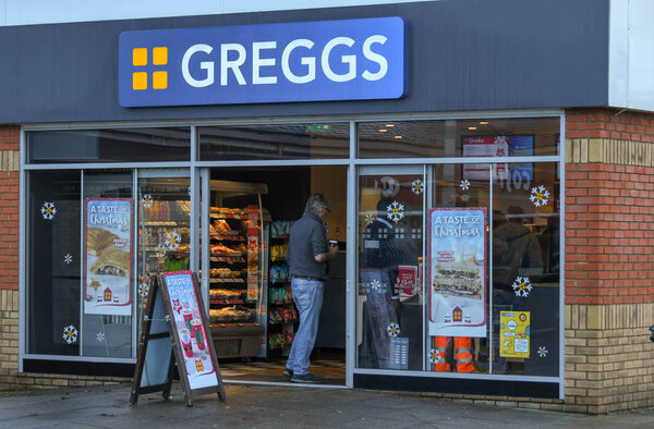 M4 SERVICES, READING, ENGLAND - NOVEMBER 2018: Customer entering a branch of the Greggs at the M4 service station in Reading.