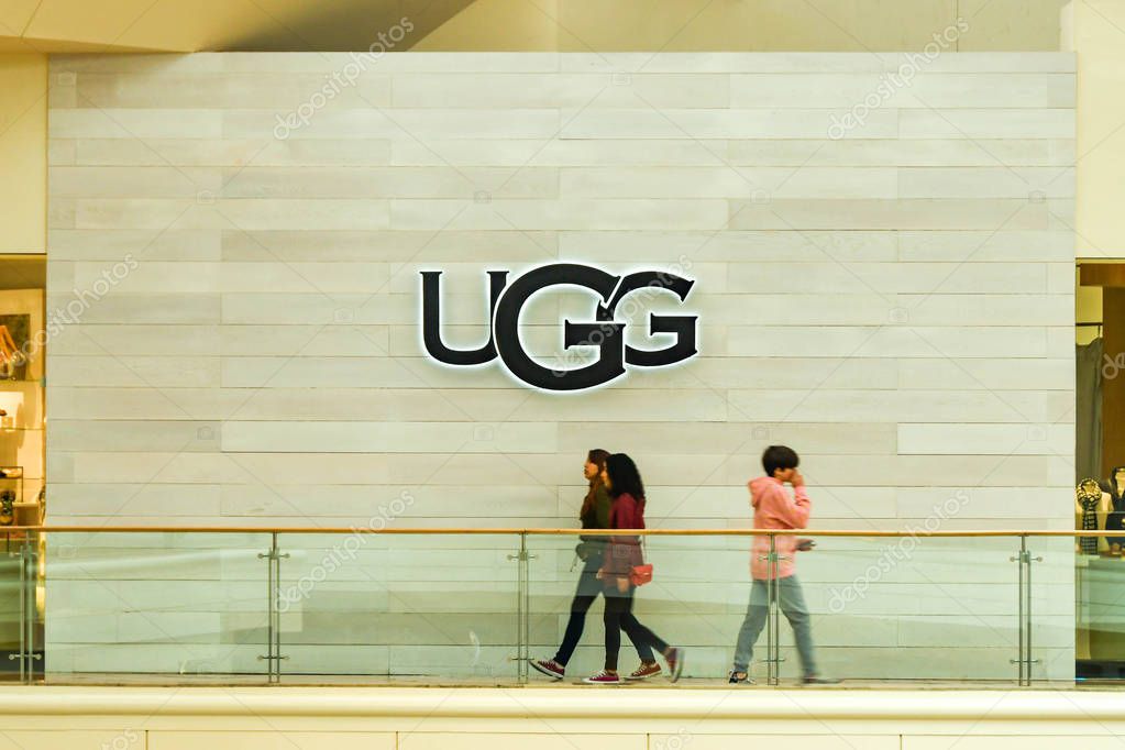 LAS VEGAS, NV, USA - FEBRUARY 2019: Young people walking past the logo of UGG in a shopping mall in Las Vegas.