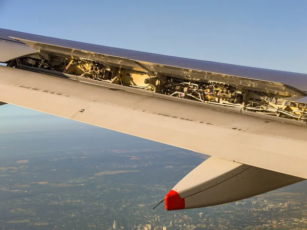 Air brakes open on the wing of a passenger jet