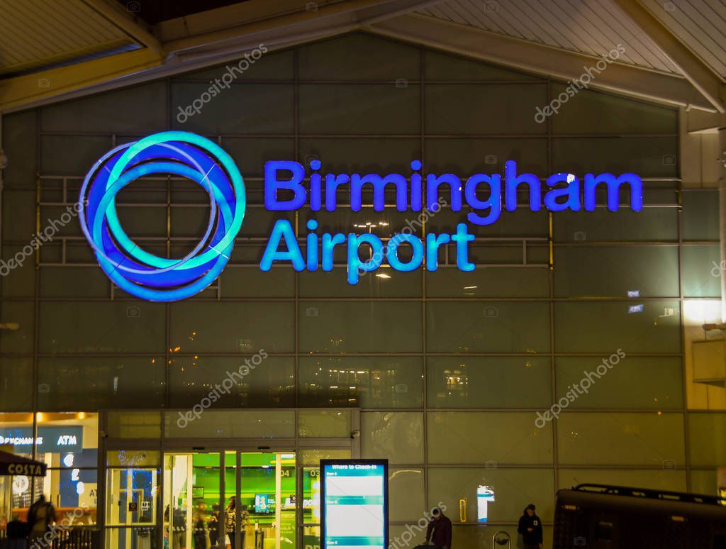 BIRMINGHAM INTERNATIONAL AIRPORT, ENGLAND - SEPTEMBER 2018: Illuminated sign on the outside of the terminal building at Birmingham International Airport.