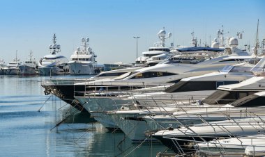 Superyachts lined up in Cannes harbour clipart