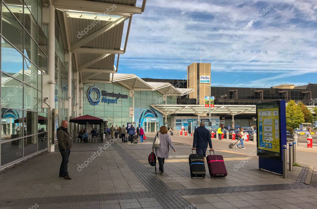 BIRMINGHAM, ENGLAND - SEPTEMBER 2018: People outside the terminal building after arriving at Birmingham International Airport.