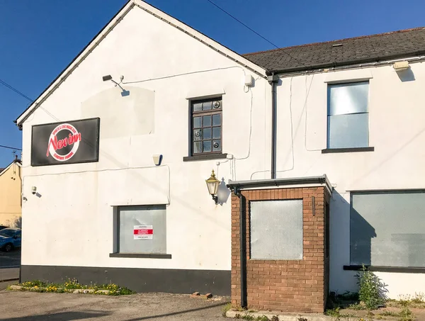 Stock image PONTYPRIDD, WALES - APRIL 2019: Public house owned by Admiral Taverns near Pontypridd which has closed down. The windows and door have been secured with steel metal plates to prevent vandalism.