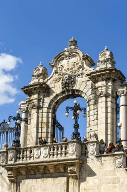 Budapeşte, Macaristan - Mart 2018: Budapeşte Kalesi'nin bahçesinde ki süslü taş kapı. İnsanlar kapının önündeki balkonda duruyorlar..