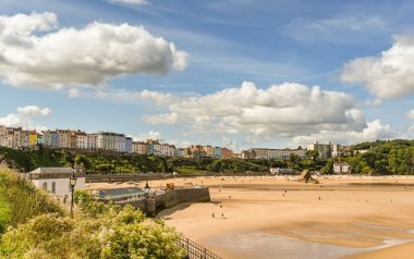 Tenby, Pembrokeshire, Galler - Ağustos 2018: Tenby, Batı Galler'deki liman duvarı ve North Beach, düşük gelgitte.