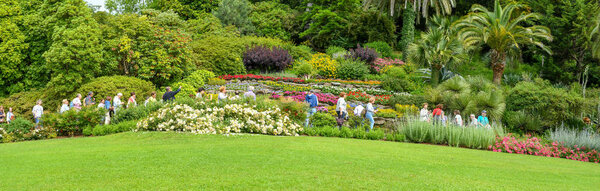 TREMEZZO, LAKE COMO, ITALY - JUNE 2019: People viewing the floral displays in the botanical gardens at the Villa Carlotta in Tremezzo on Lake Como.