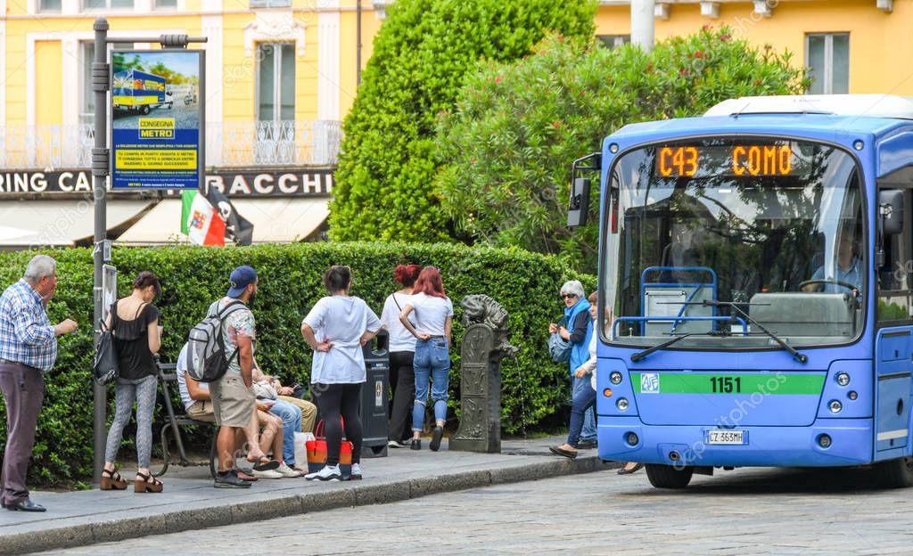 COMO, ITALY - JUNE 2019: Bus arriving at a bus stop in Como on Lake Como.