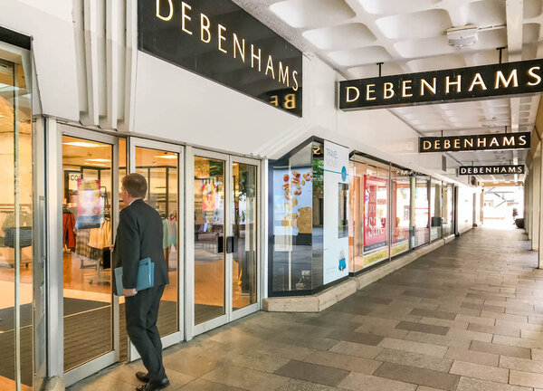 CARDIFF, WALES - JULY 2019: Person going into the Debenhams department store in Cardiff city centre