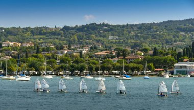 Bardolino, Garda Gölü, İtalya - Eylül 2018: Garda Gölü'ndeki Bardolino'da yelken kursuna katılan dinghies'deki çocuklar.