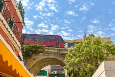 ISLE OF CAPRI, ITALY - AUGUST 2019: Train on the funicular railway approaching the base station in the port on on the Isle of Capri. clipart